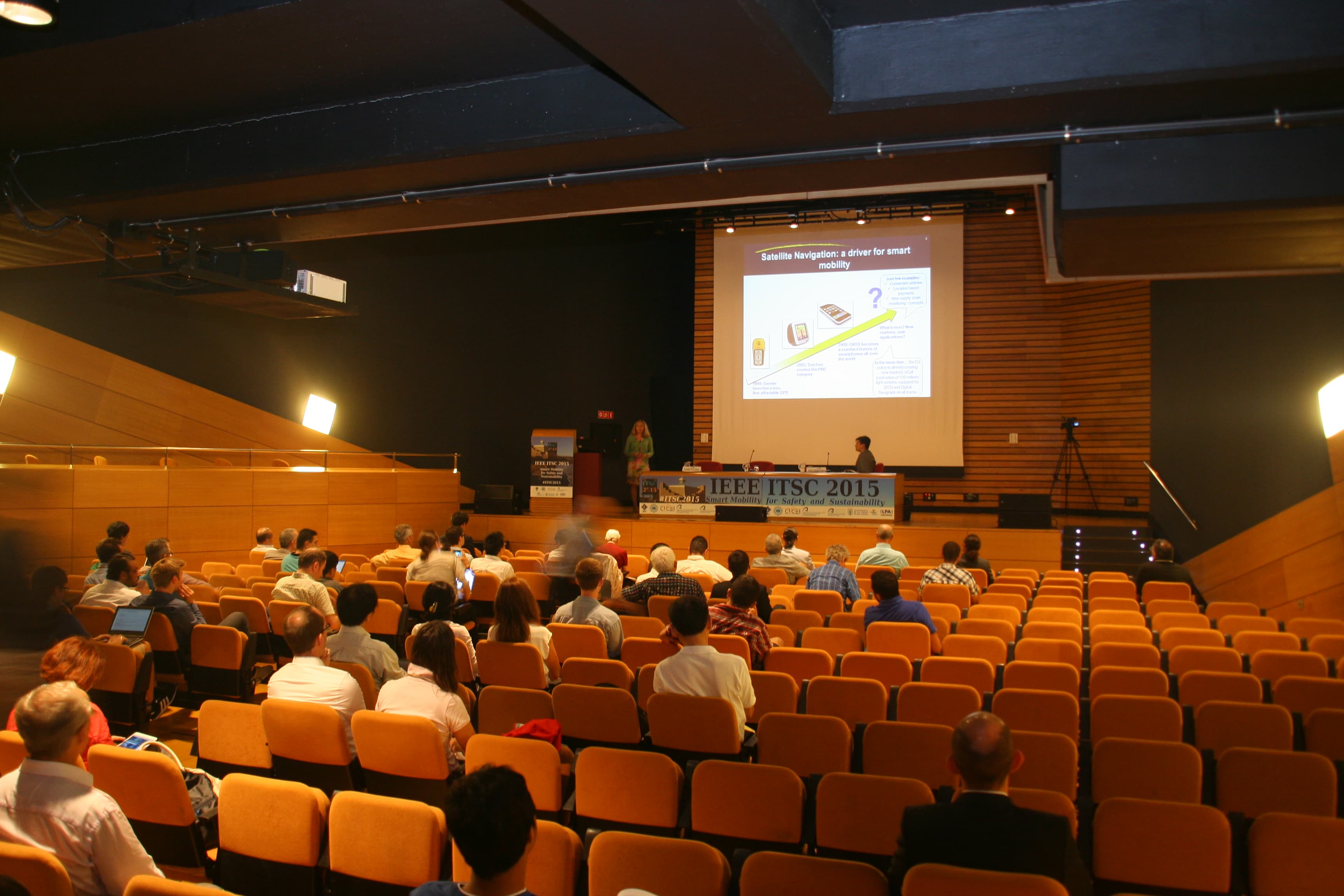 Audience in a university auditorium during a presentation