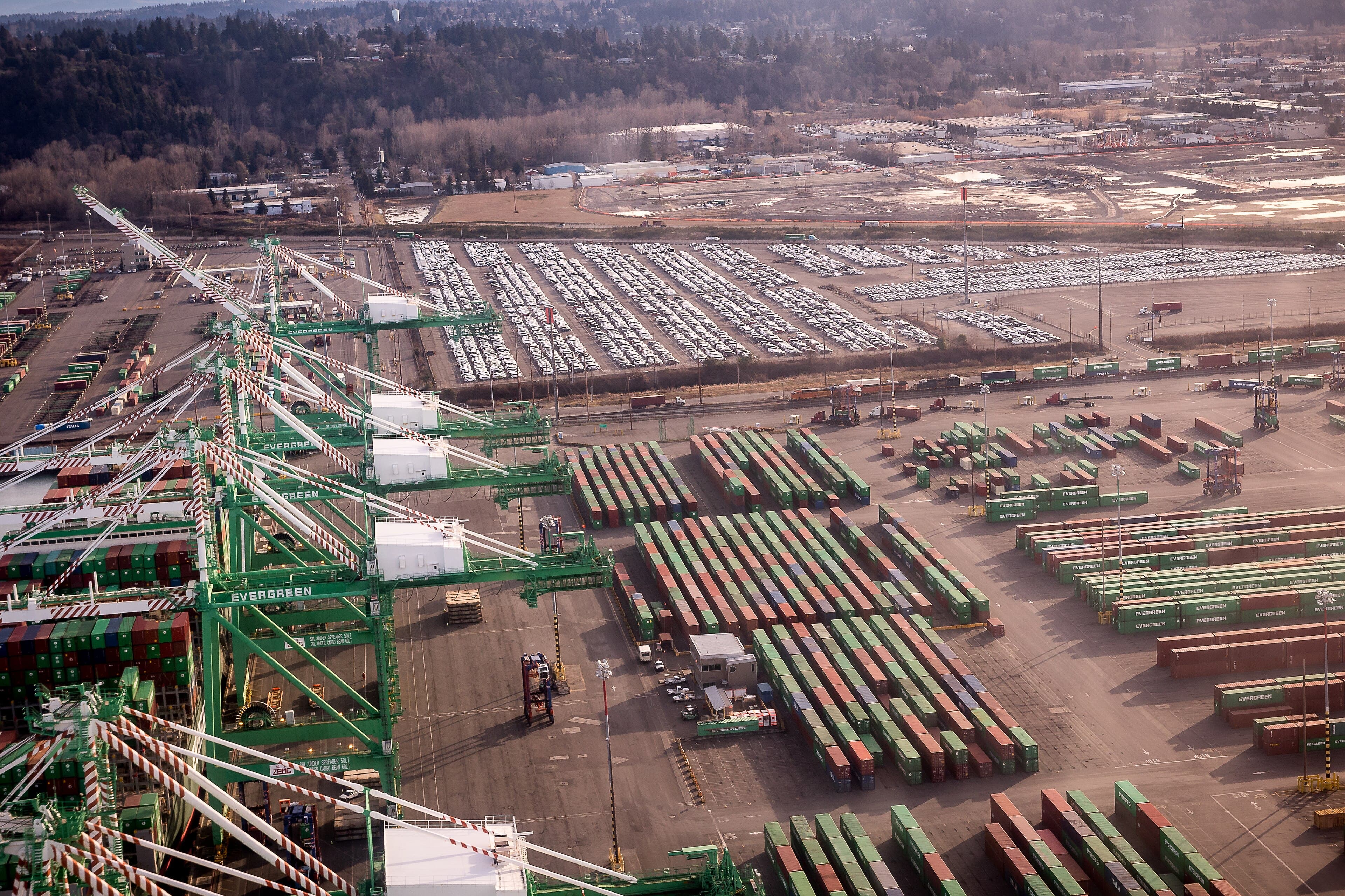 Aerial view of a container terminal, with gantry cranes working a ship alongside